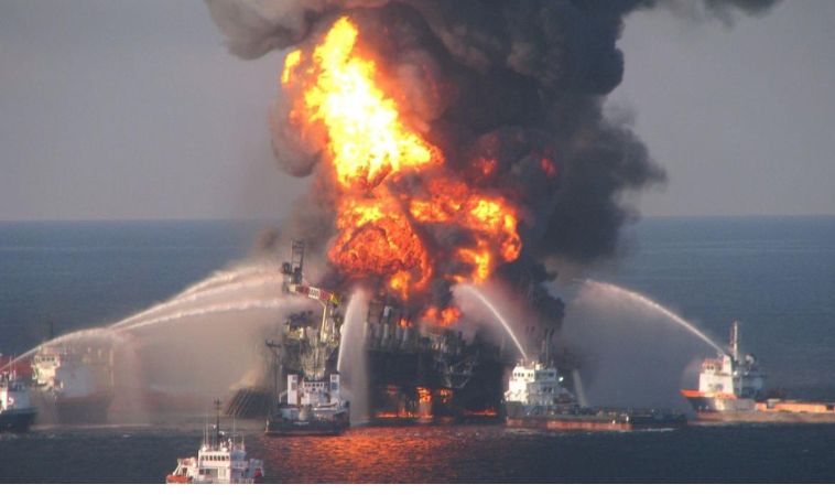 Firefighting ships battle a massive blaze aboard an oil tanker in the Gulf of Oman, with thick black smoke and flames rising high above the vessel during a rescue operation.