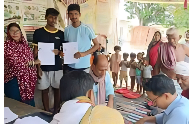 Citizens submitting documents at a voter registration camp in a rural village in India, supervised by election officials and locals